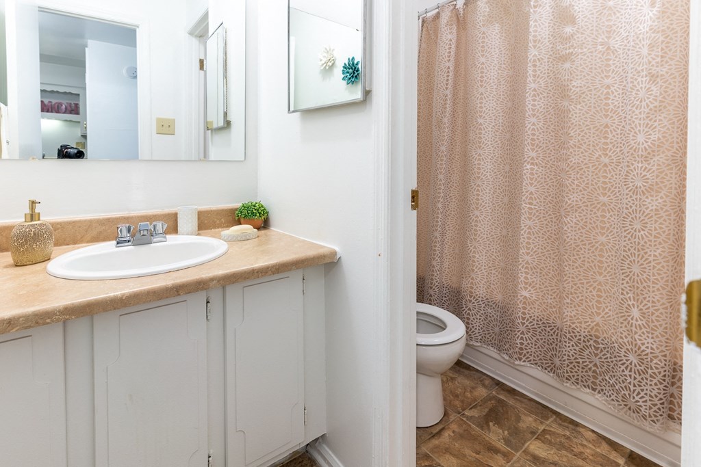 a bathroom with a sink and a toilet and a shower at Lake Camelot Apartments, Indiana, 46268
