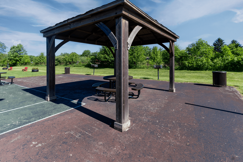 a pavilion with a picnic table in a park at Pickwick Farms Apartments, Indiana
