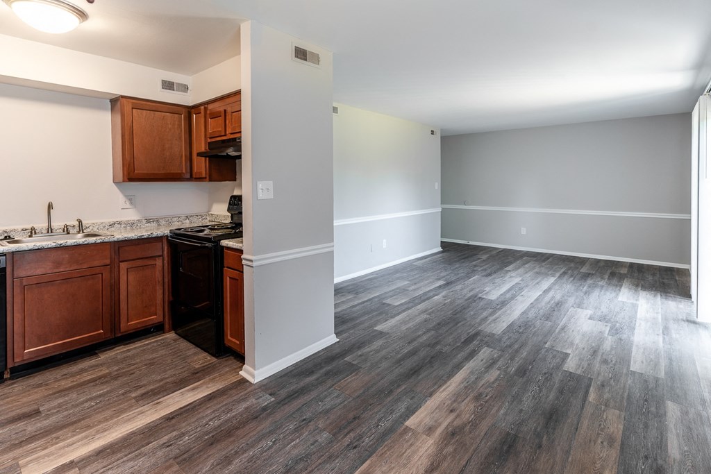 an empty kitchen and living room with wood flooring at Pickwick Farms Apartments, Indiana