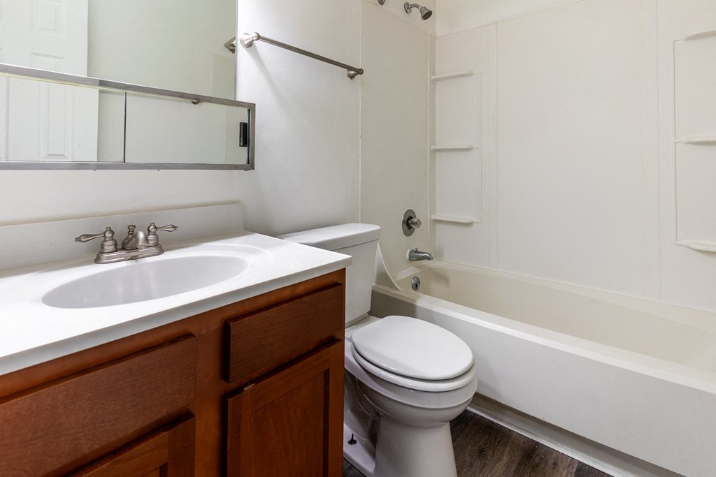 an empty bathroom with a sink toilet and bath tub at Pickwick Farms Apartments, Indianapolis, IN