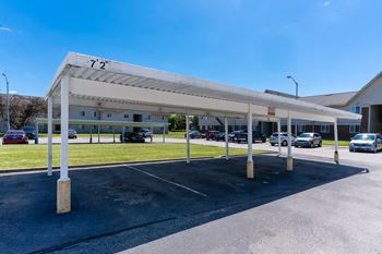 a parking lot with cars parked in front of a building