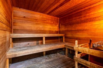 a sauna with wooden benches and wooden walls at Walnut Creek Apartments, Kokomo, Indiana