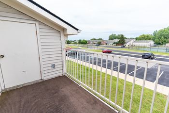 the view from the balcony of a house overlooking a parking lot at Walnut Creek Apartments, Kokomo