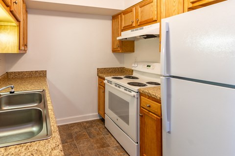 a kitchen with a stove refrigerator and sink