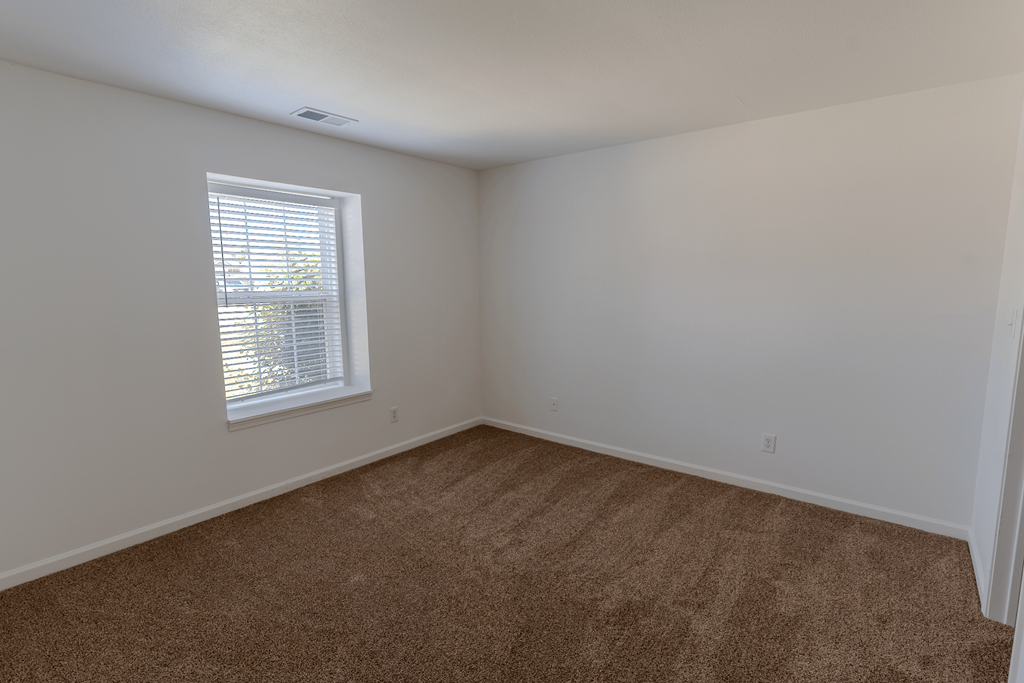 an empty room with carpet and a window at Barton Farms in Greenwood, IN 46143
