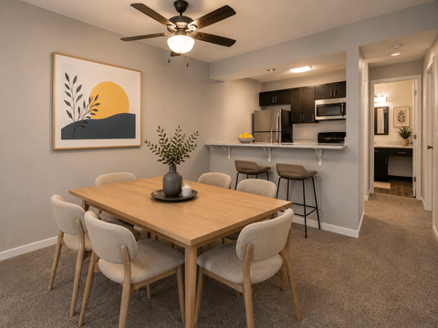 A dining room with a wooden table and chairs.