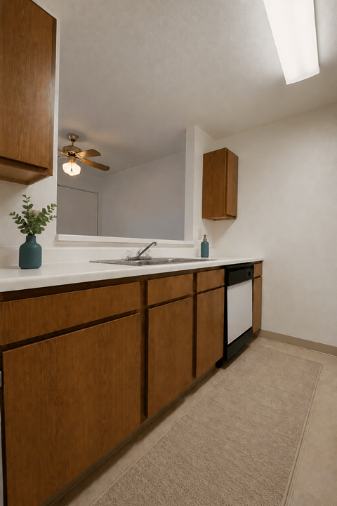 A kitchen with wooden cabinets and a white countertop.