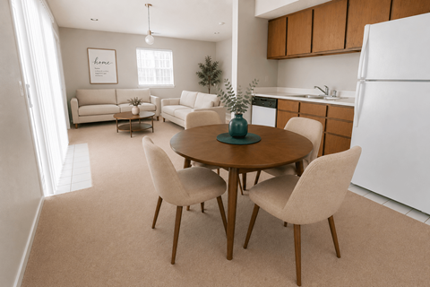 A dining room with a round table and chairs.