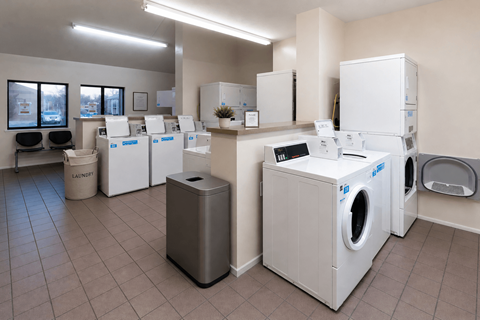 A laundry room with washers and dryers.