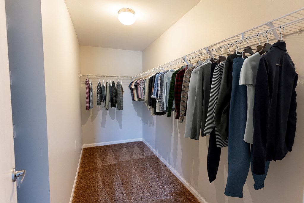 a closet with a rack of clothes at Walnut Creek Apartments, Indiana