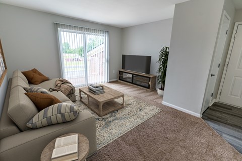 an open living room with a couch and a tv