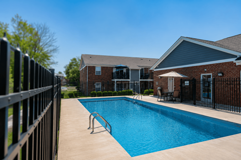 A swimming pool surrounded by a black fence.