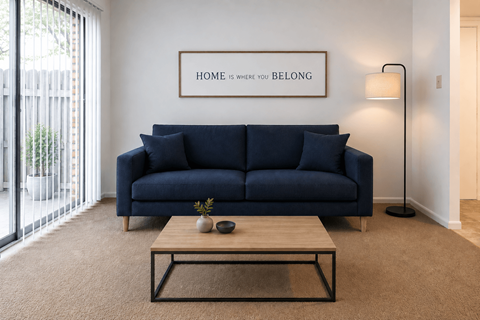 A living room with a blue couch and a coffee table.