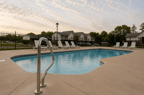 A swimming pool with a metal ladder in the foreground.