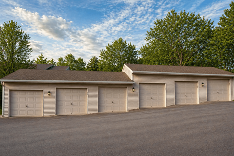 A large building with a brown roof and six garage doors.