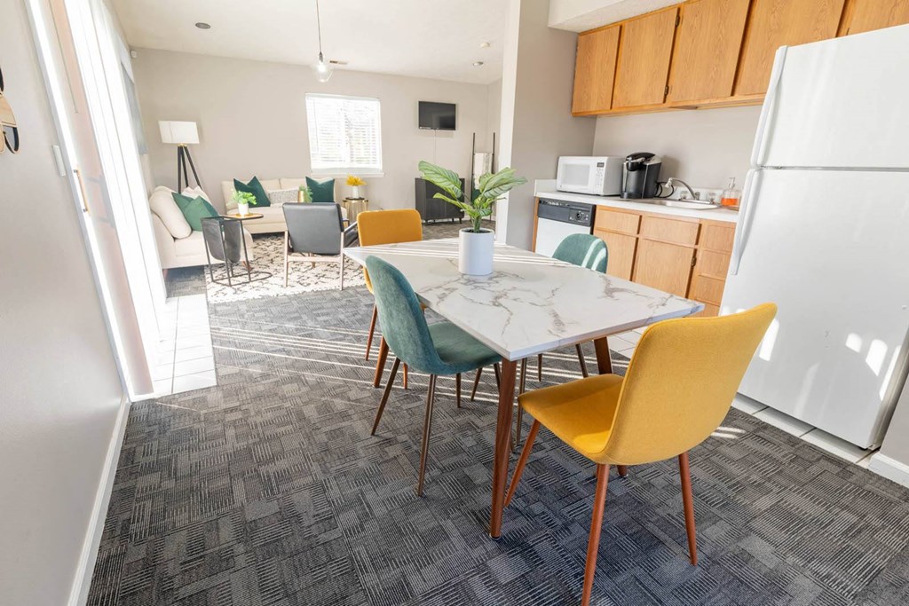 a kitchen and dining room with a table and chairs at Creekside Square Apartments, Indiana