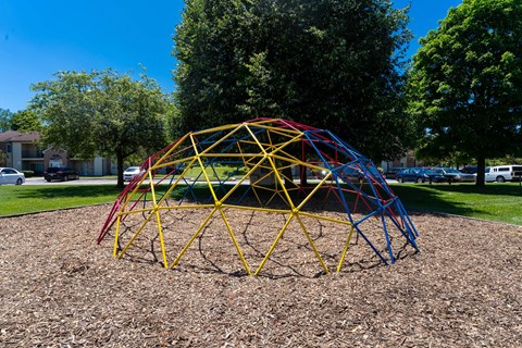a pyramid of playground equipment in a park