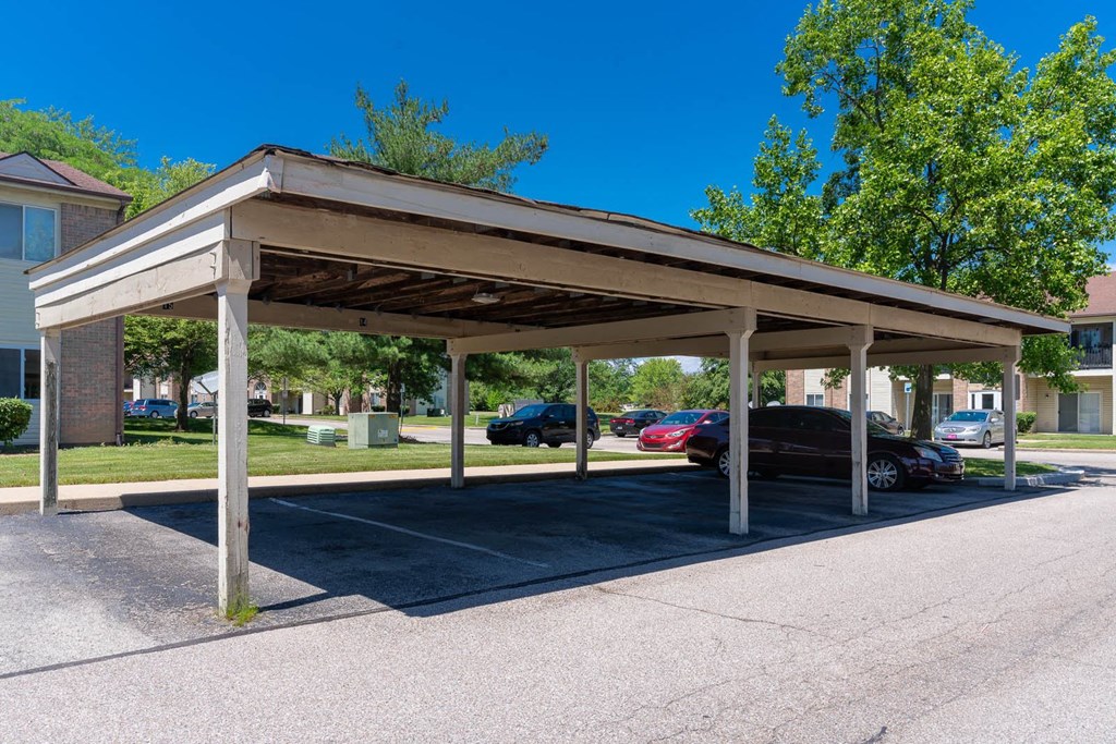 a covered parking lot with cars parked in it at Creekside Square Apartments, Indianapolis, IN