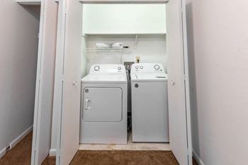 a small laundry room with two washes and a dryer