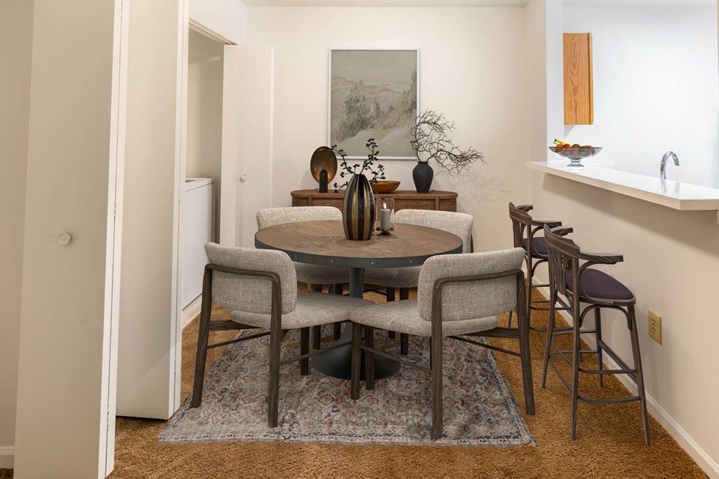 a dining room with a table and chairs