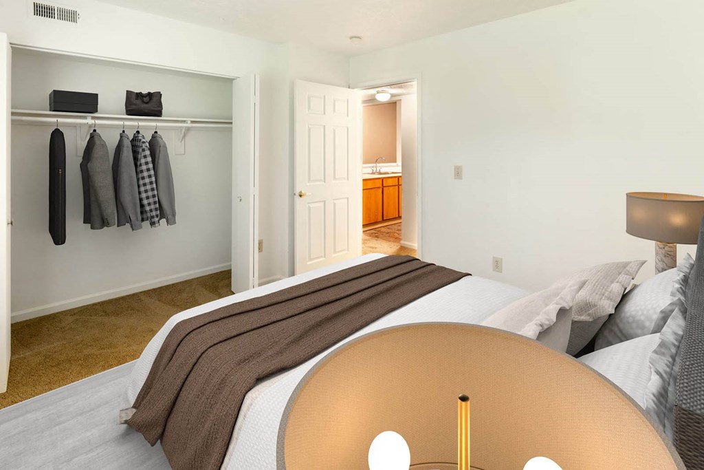 a bedroom with a bed and a closet