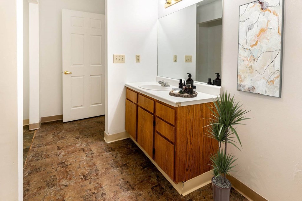 a bathroom with a sink and a mirror at Creekside Square Apartments, Indianapolis, IN