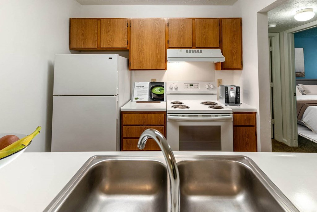 a kitchen with a sink stove and refrigerator at Creekside Square Apartments, Indiana