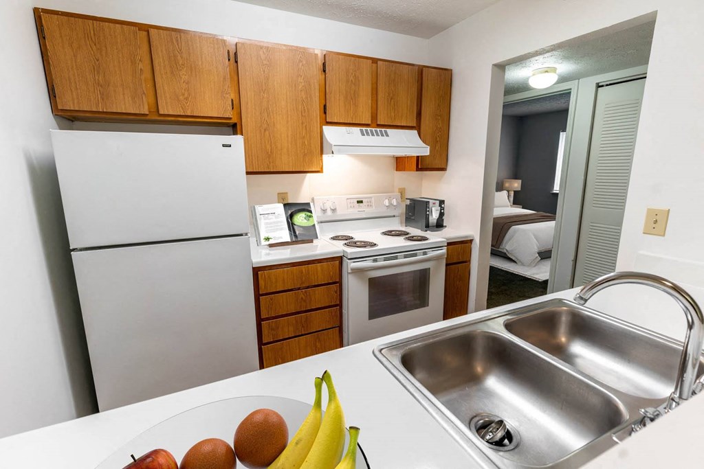 a kitchen with stainless steel appliances and a sink at Creekside Square Apartments, Indianapolis
