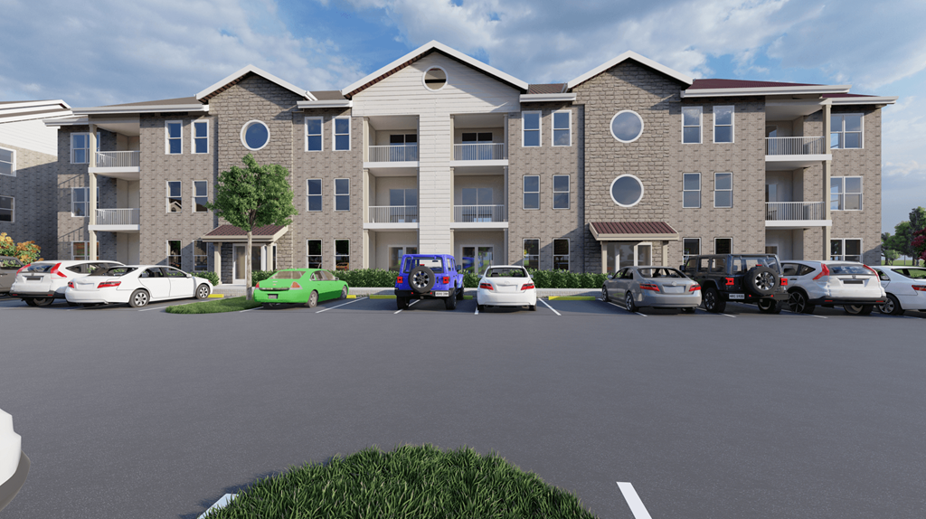 a large apartment building with cars in a parking lot