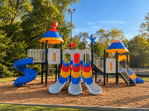 A playground with a slide and a large sock-like structure in the middle.