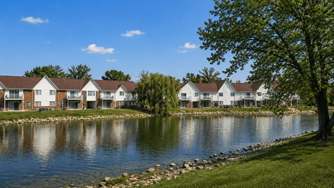 A row of houses are by a body of water.