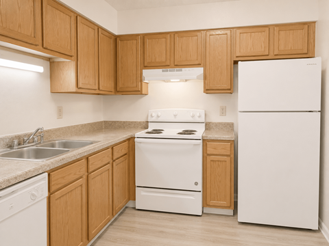 A kitchen with wooden cabinets and white appliances.