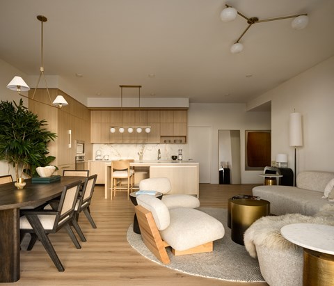 A modern living room with a dining table and chairs.