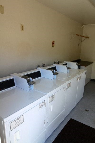 a row of white washing machines in a room