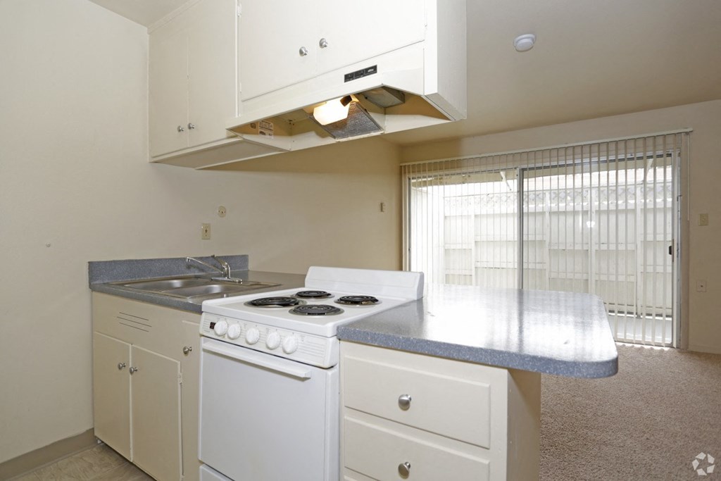 a kitchen with white appliances and a counter top