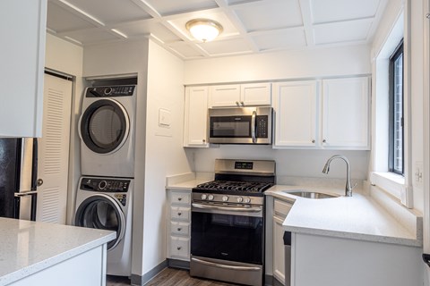 a kitchen with a washer and dryer and a sink