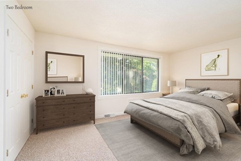 a bedroom with a bed and a dresser and a window