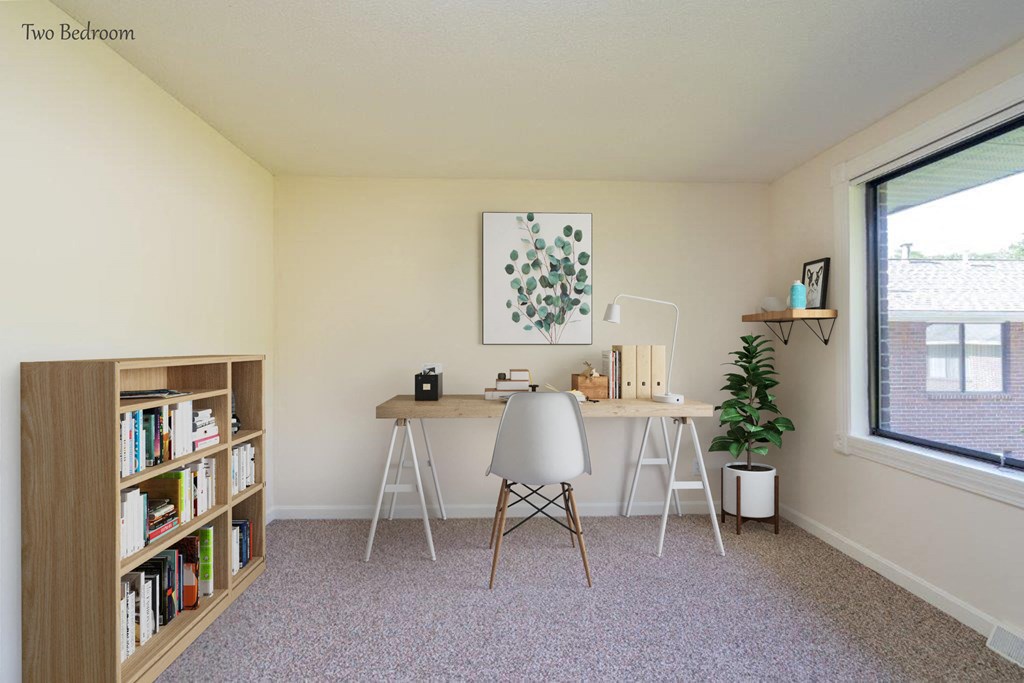 a home office with a desk and a window