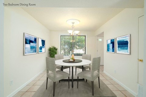 a dining room with a table and chairs