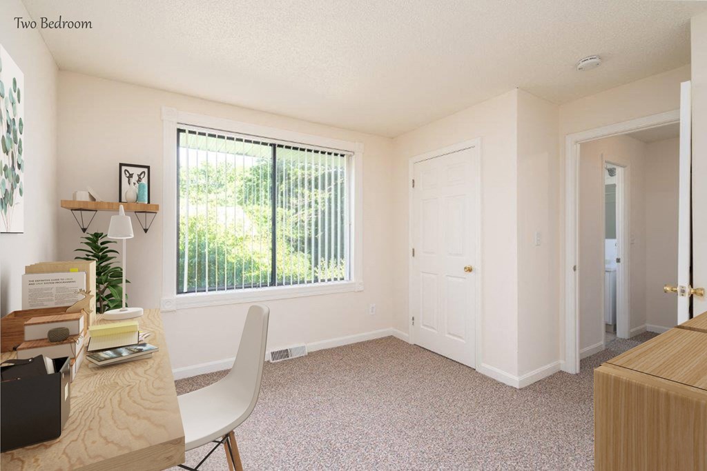 an office with a large window and a desk