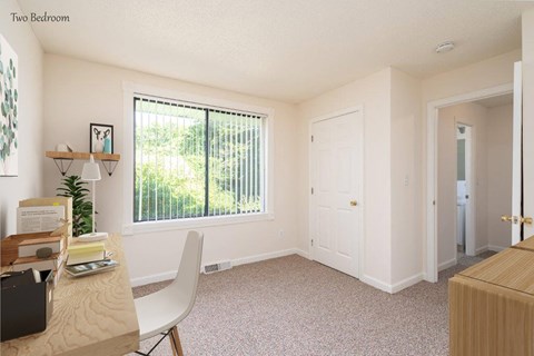 an office with a large window and a desk