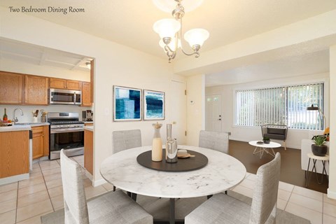 a kitchen and dining room with a marble table and chairs