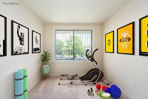 a workout room with an exercise bike and a window