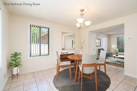 a dining room with a wooden table and chairs
