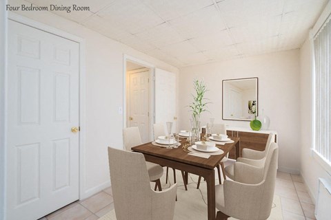 a dining room with a wooden table and white chairs