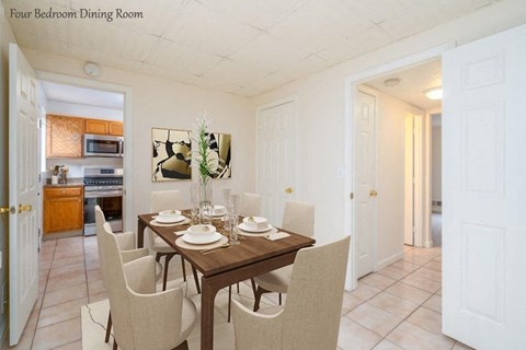 a dining room with a wooden table and chairs
