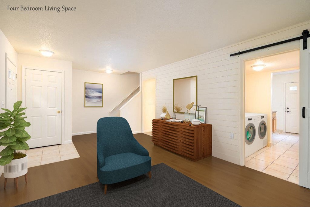 a living room with a blue chair and a washer and dryer