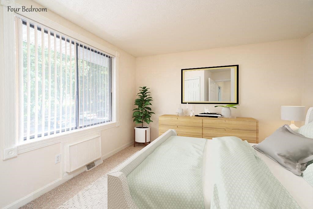 a bedroom with a white bed and a large window