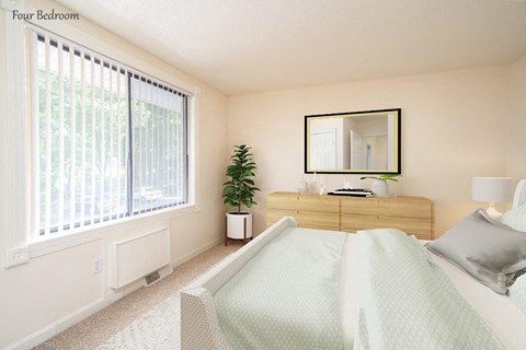 a bedroom with a white bed and a large window