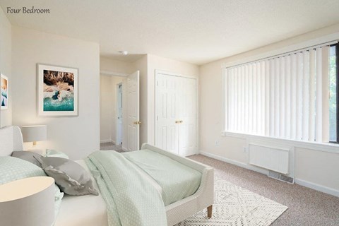 a bedroom with a bed and a chair and a window